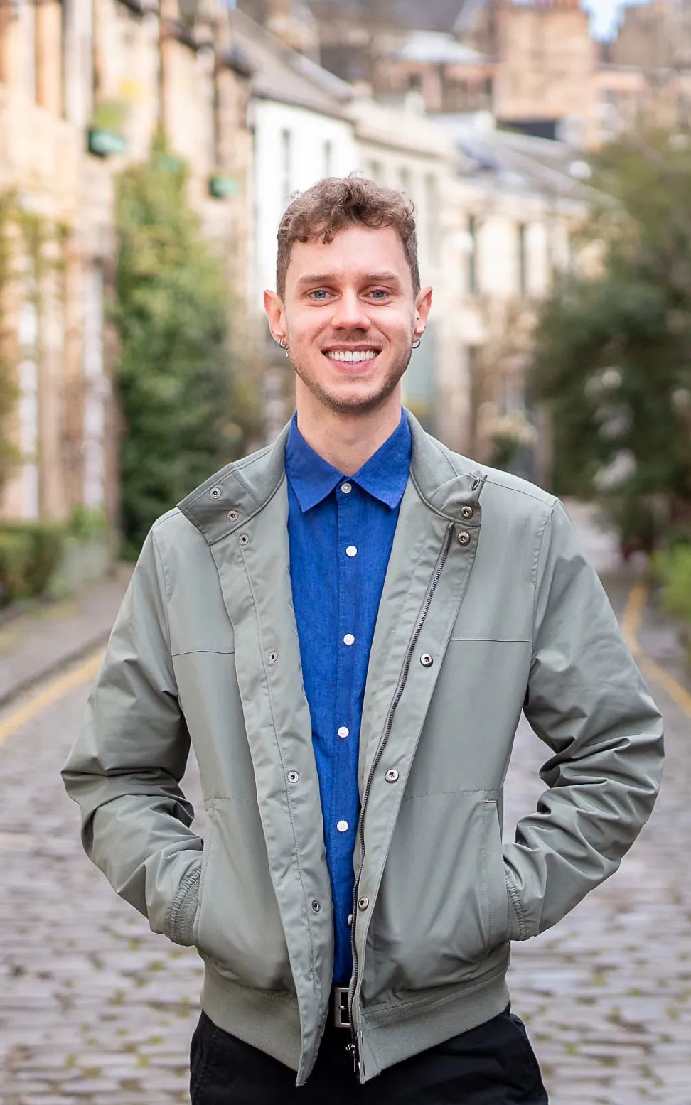 Chris smiling in a cobbled street